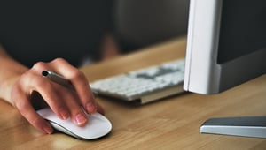 Image of a person's hand on a computer mouse