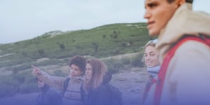 Group of people in a hilly landscape wearing clothes made by tamigo customer Salomon.